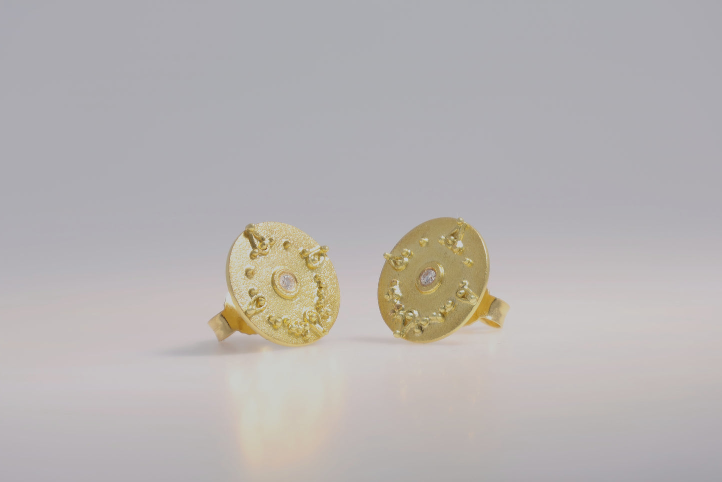 Round stud earrings with diamond and detailing