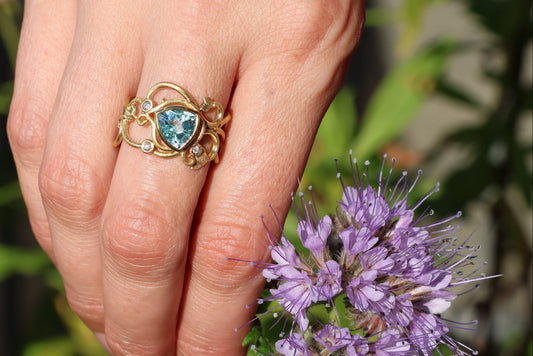 Gold ring with topaz stones and diamonds. Vines and tendrils.